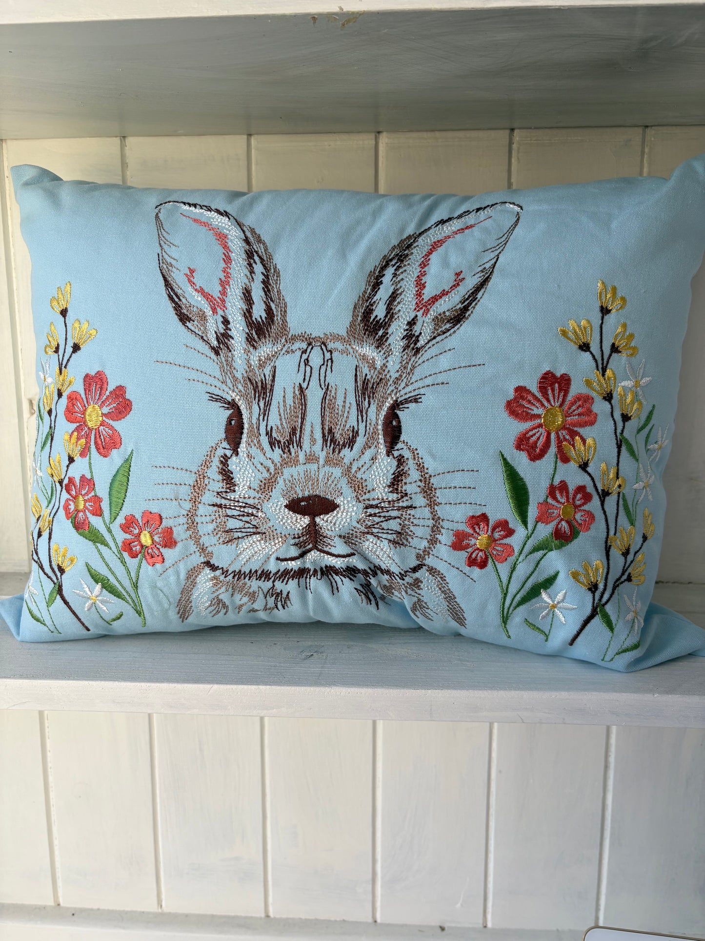 Embroidered rabbit design oblong cushion