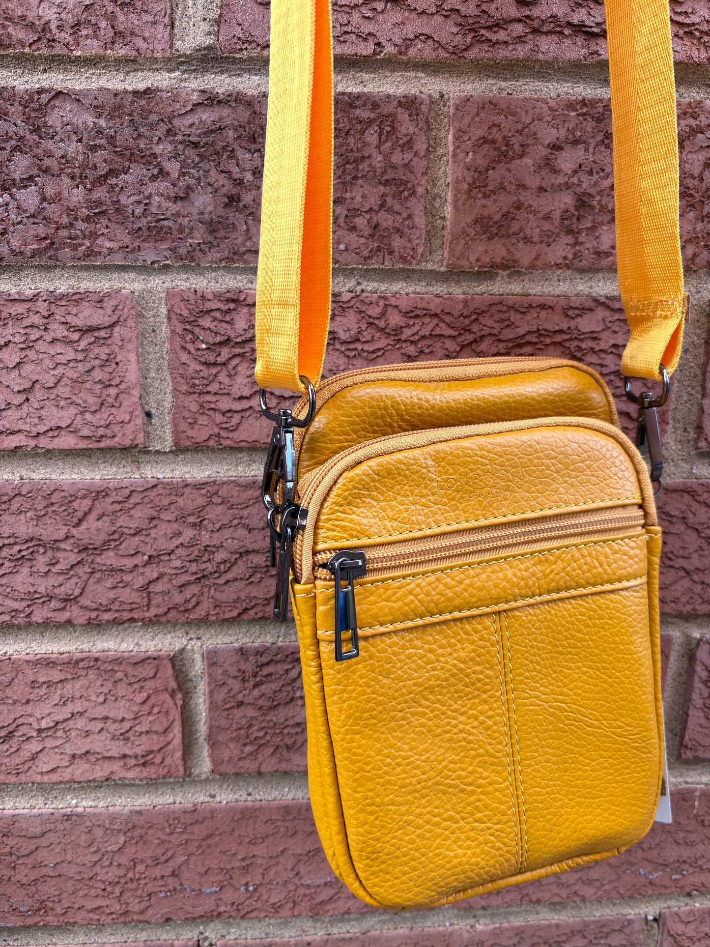 Leather style cross body bag with zipped pockets mustard colour