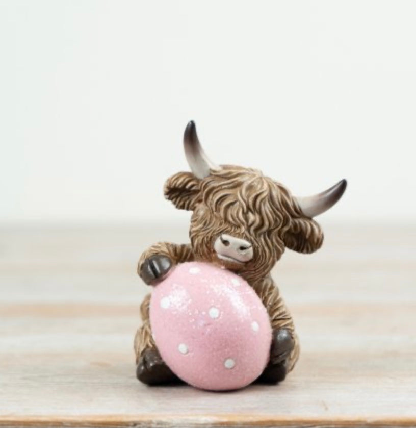 Highland cow with easter egg