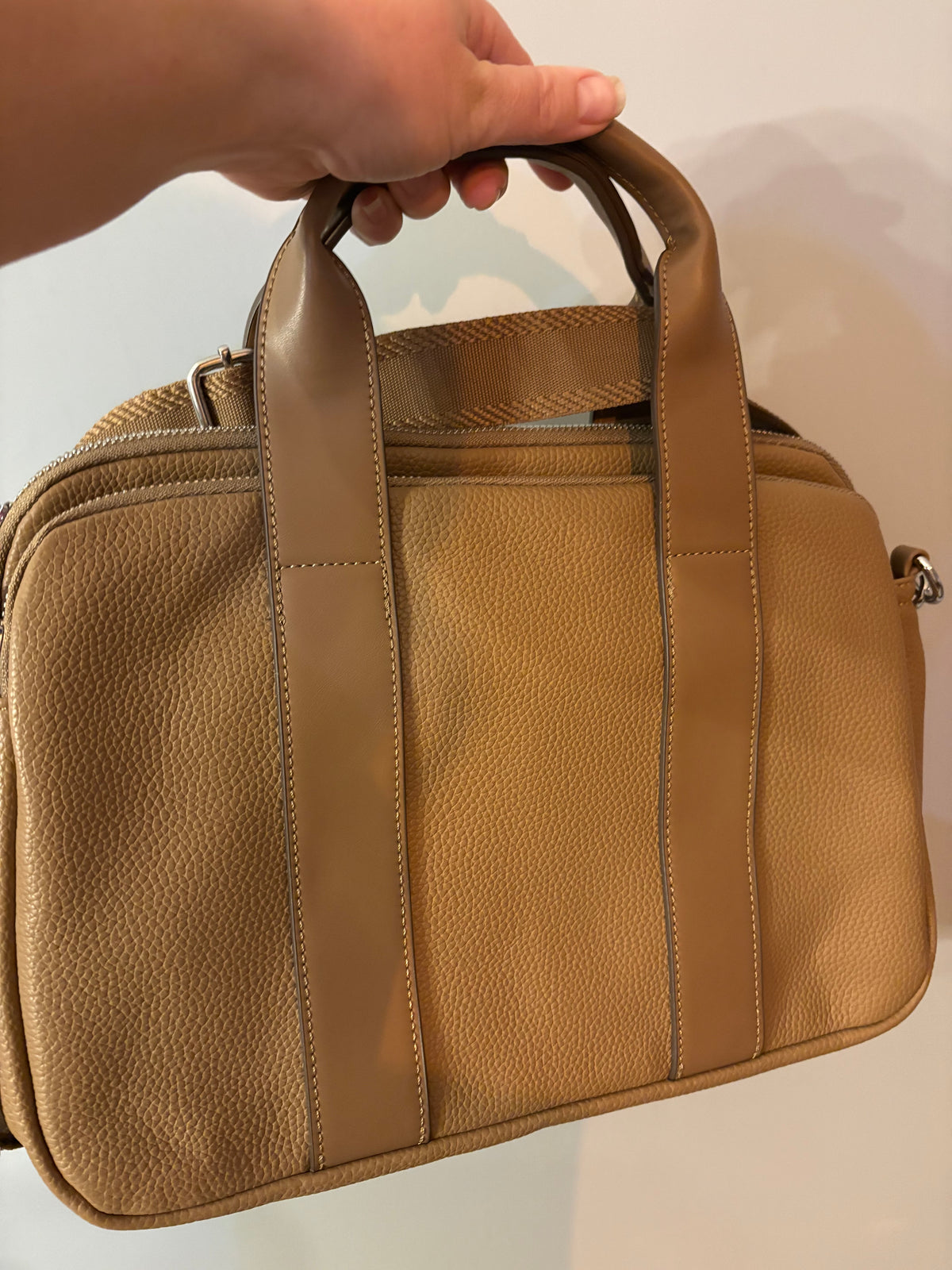 Hand held bag with zipped compartments and strap
